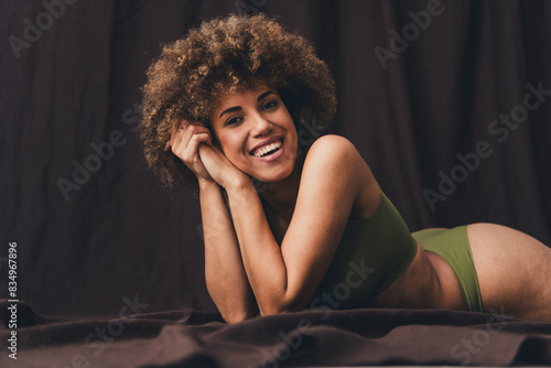 Photo of lovely young lady lying dreamy girlish floor dressed khaki lingerie studio background no filter self acceptance all body perfect