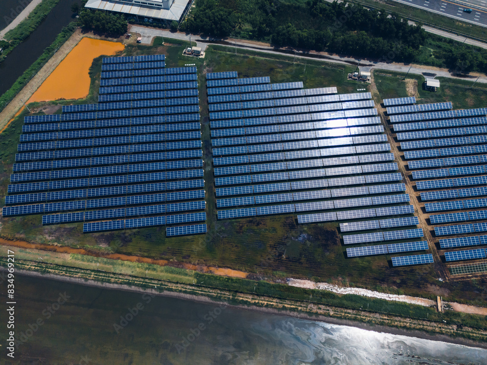 Obraz premium Ecology solar power station panels in the fields green energy . Aerial view of Solar panel, photovoltaic, alternative electricity source. Concept of sustainable resources.