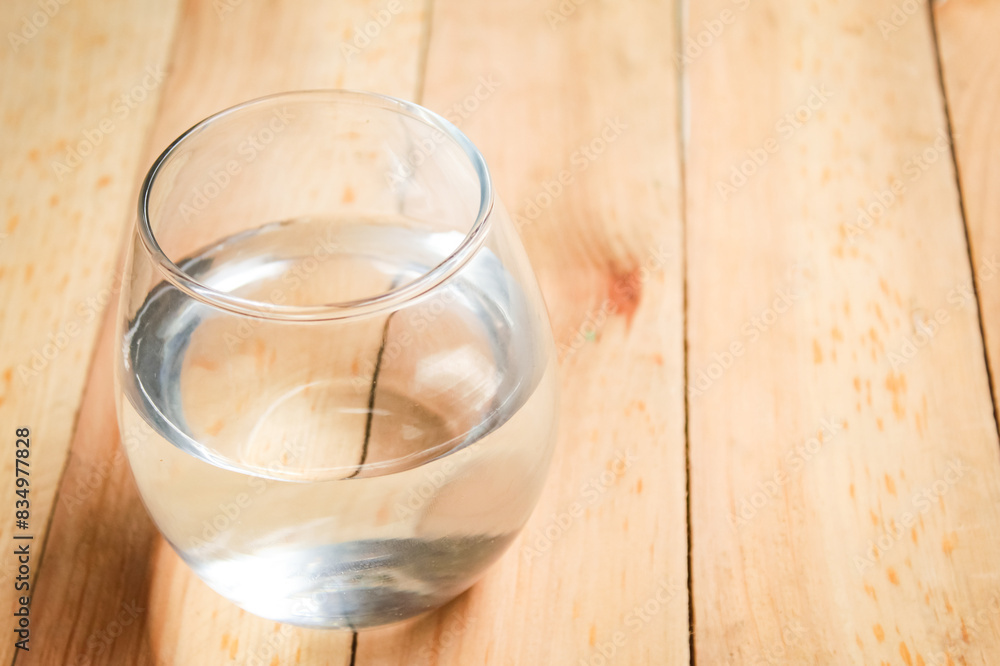 glass of water on wooden table glass of water on wooden table