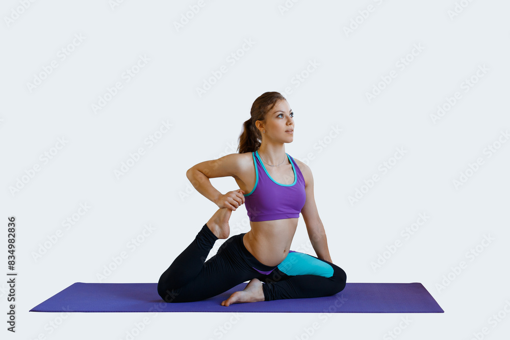 Fit beautiful young woman with sportswear sits and stretches her legs on a dark background. Girl warming up Fit beautiful young woman with sportswear sits and stretches her legs on a dark background. Girl warming up