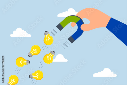 Imagination to create new ideas, businessman with magnet to magnetize light bulb ideas.