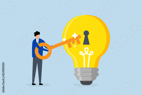 Unlock new business idea, businessman with golden key will insert key into bulb idea lamp.