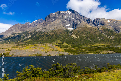 Torres del Paine national park in Patagonia Andes, Chile. South America mountain landscape. Beautiful mountains Los Cuernos, Torres del Paine and Paine Grande tower peaks near lake on a sunny day