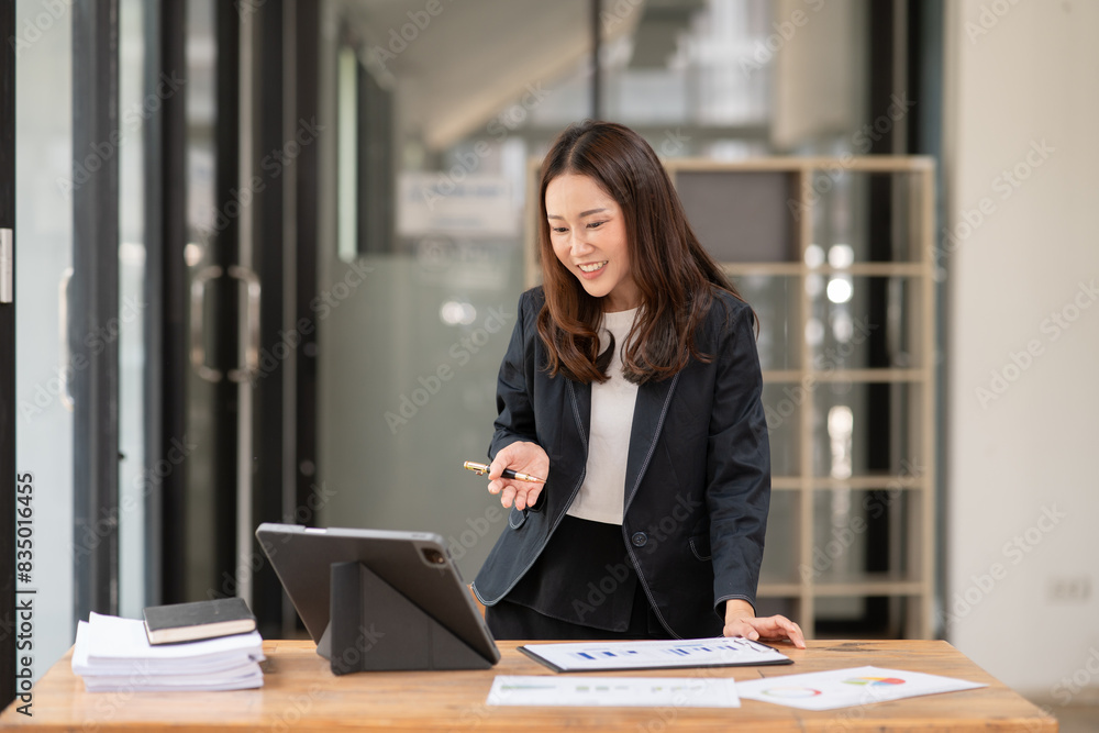 Asian business woman working with tablet. Asian business woman working with tablet.