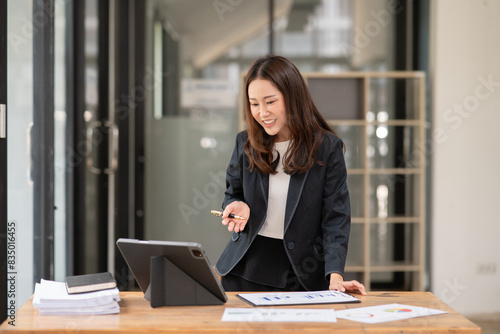 Asian business woman working with tablet. © Thitisak