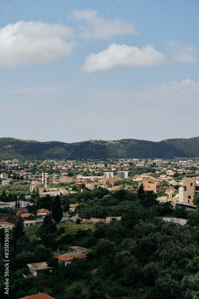 The view of the tiled roofs of houses is a popular Balkan style of construction. View from the old fortress of the town on the mountain. Montenegro, the city Bar on the Adriatic coast.