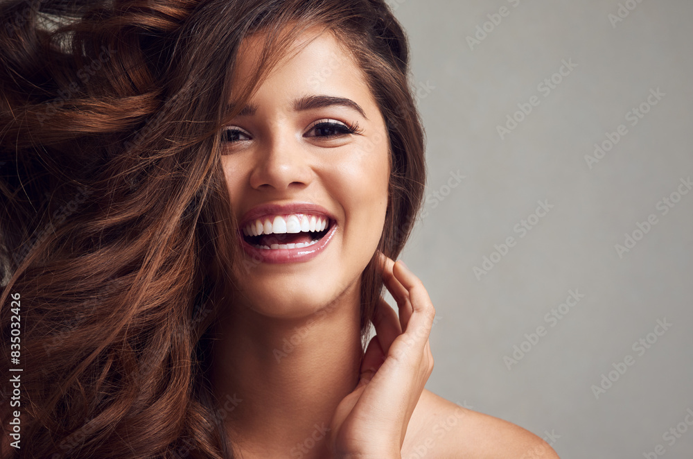 Happy, hair and space with portrait of woman in studio on gray background for keratin or shampoo treatment. Beauty, cosmetics and smile with model at salon for conditioning or natural haircare Happy, hair and space with portrait of woman in studio on gray background for keratin or shampoo treatment. Beauty, cosmetics and smile with model at salon for conditioning or natural haircare