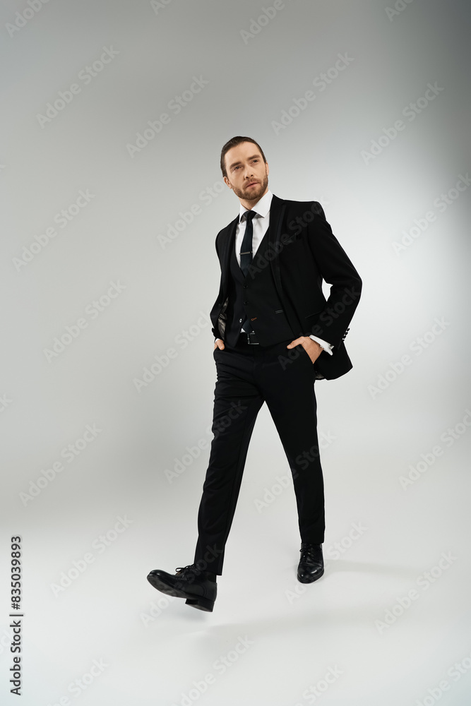 Bearded businessman exudes confidence in stylish suit and tie against a neutral background. Bearded businessman exudes confidence in stylish suit and tie against a neutral background.