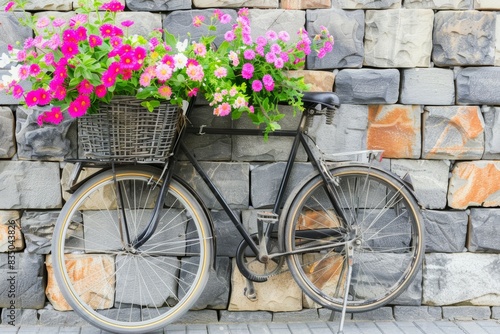 Charming vintage bicycle with floral basket by stone wall © volga