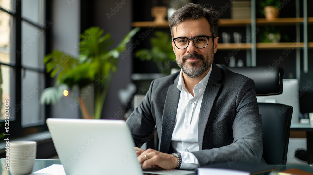 Young professional with beard looking thoughtfully while sitting at desk in modern office. Generative AI Young professional with beard looking thoughtfully while sitting at desk in modern office. Generative AI