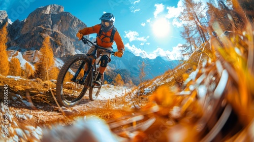 A dynamic shot of a mountain biker racing through a vibrant autumn forest path with mountain peaks in the background