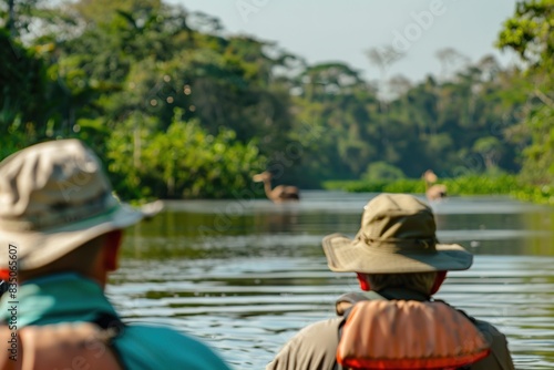 Explorers in hats watch hippos in distant river © Larisa