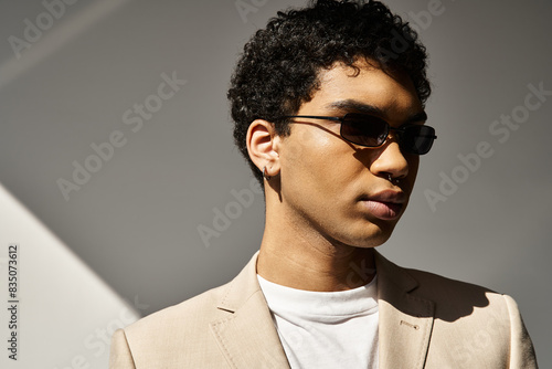 Stylish African American man in tan suit and sunglasses. photo