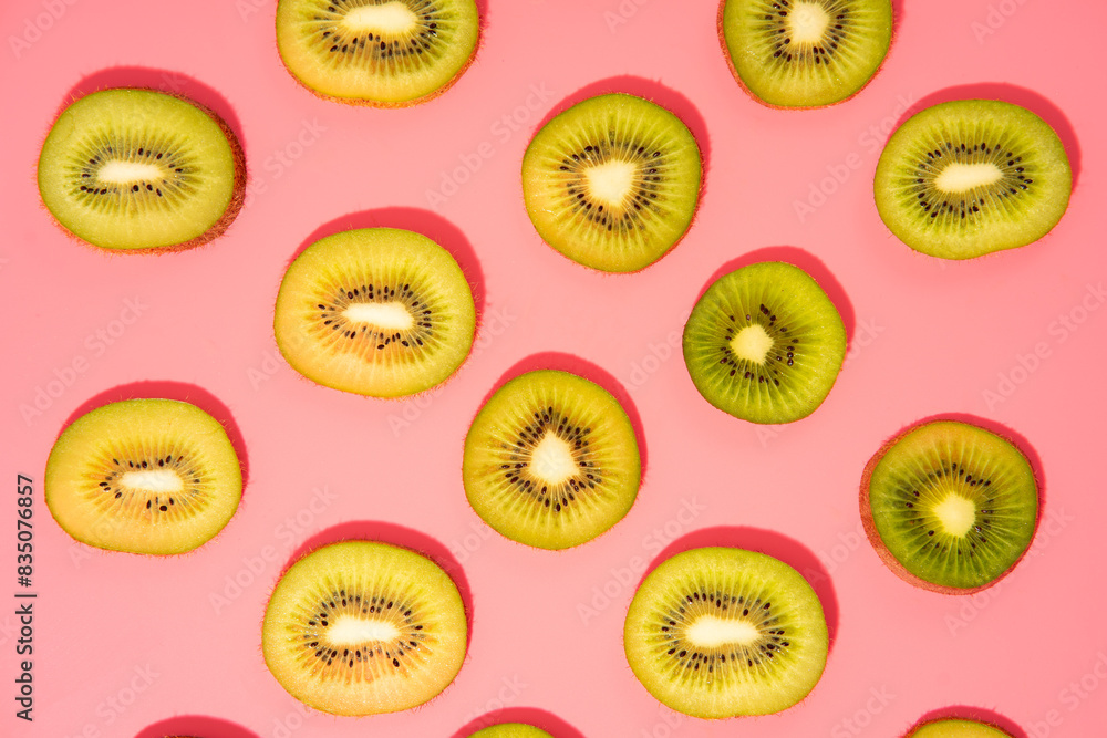 Flat lay of kiwi slices on a pink background Flat lay of kiwi slices on a pink background