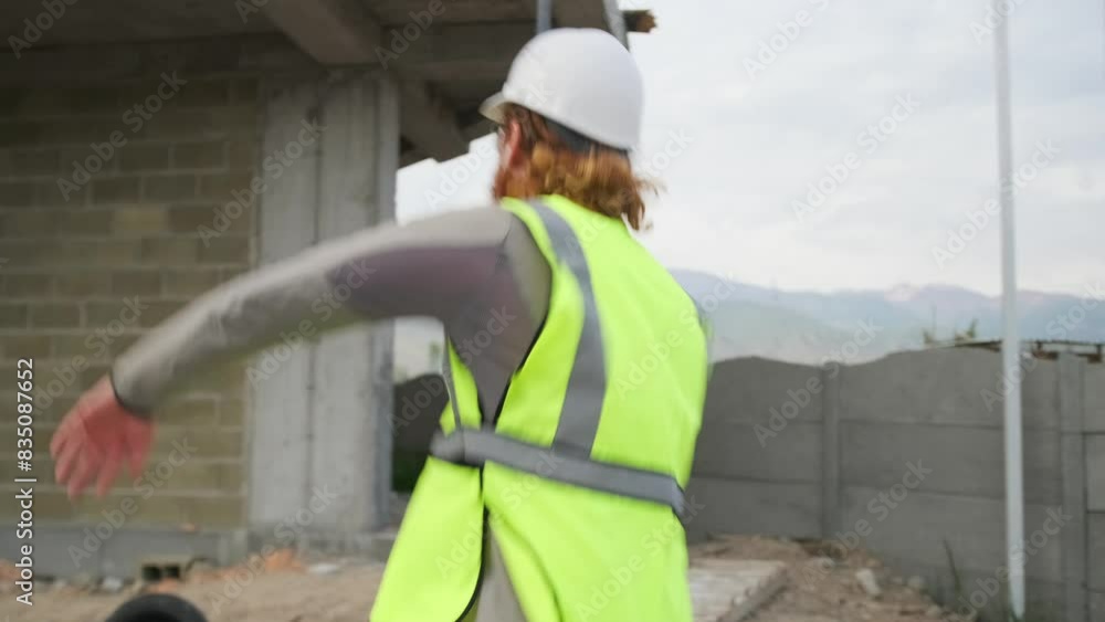 Crazy with love young construction worker dancing in joyful excitement on construction site listening and singing along to music on headphones. Crazy with love young construction worker dancing in joyful excitement on construction site listening and singing along to music on headphones.