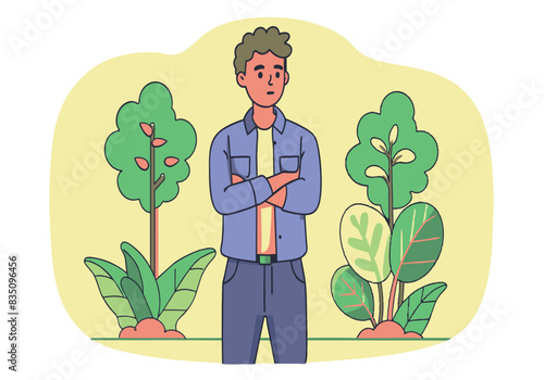 A man is standing in a park with his arms crossed