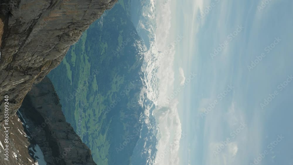 Picturesque panorama of snowy rocky mountains in Swiss Alps. Vertical video Picturesque panorama of snowy rocky mountains in Swiss Alps. Vertical video