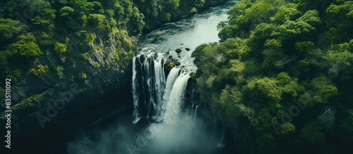 Aerial view capturing a stunning waterfall with copy space image.