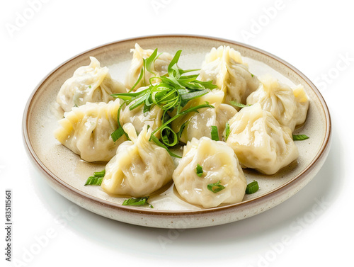 A plate of dumplings sits on a white background.