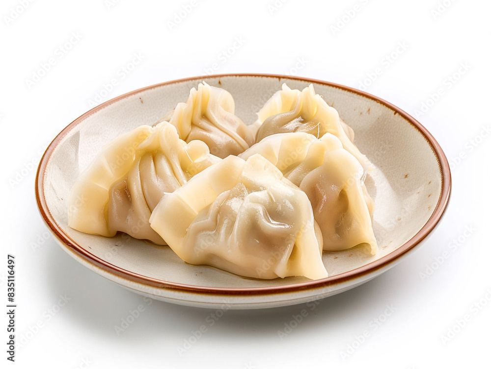 A plate of dumplings sits on a white background. A plate of dumplings sits on a white background.