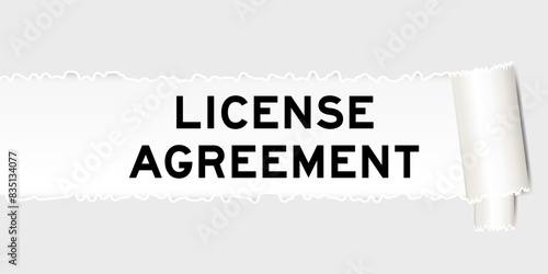 Ripped gray paper background that have word license agreement under torn part