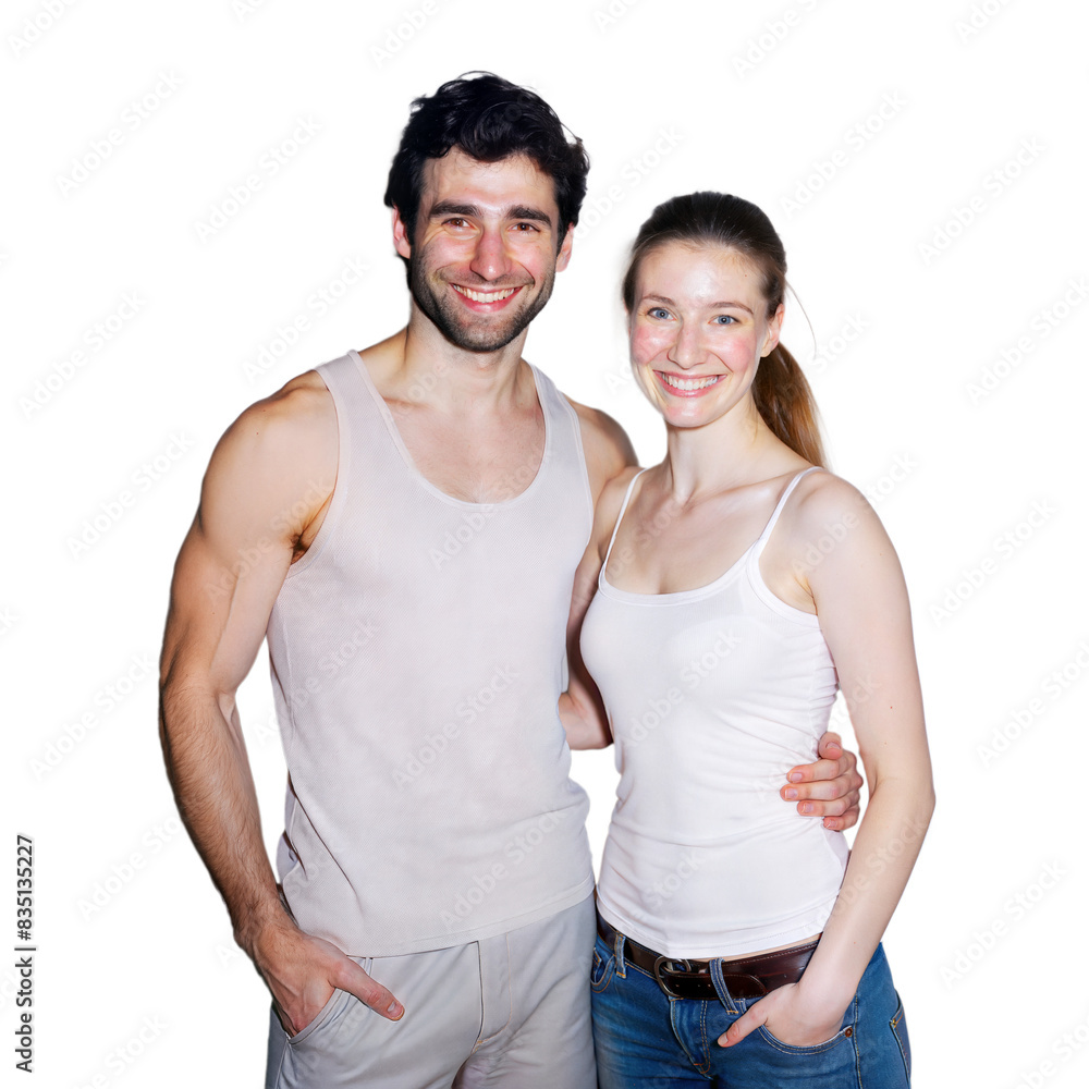A smiling couple poses together in casual tank tops indoors, looking happy A smiling couple poses together in casual tank tops indoors, looking happy