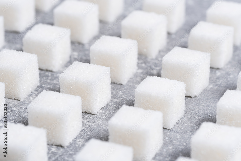 Refined sugar cubes are laid out in clear geometric lines. Refined sugar cubes are laid out in clear geometric lines.