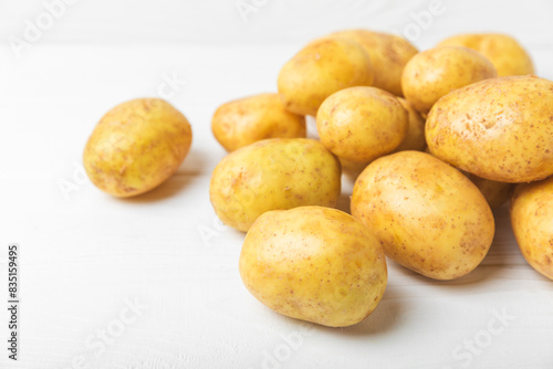 Young potatoes. Fresh potatoes  on a wooden background.Harvesting collection. organic  freshly dug potatoes. Agricultural background. Vegan. Vegetables.Place for text.Copy space