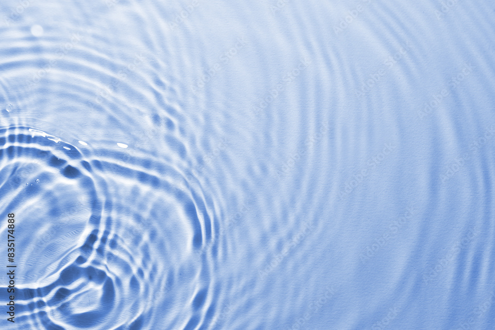 Rippled surface of clear water on light blue background, top view Rippled surface of clear water on light blue background, top view