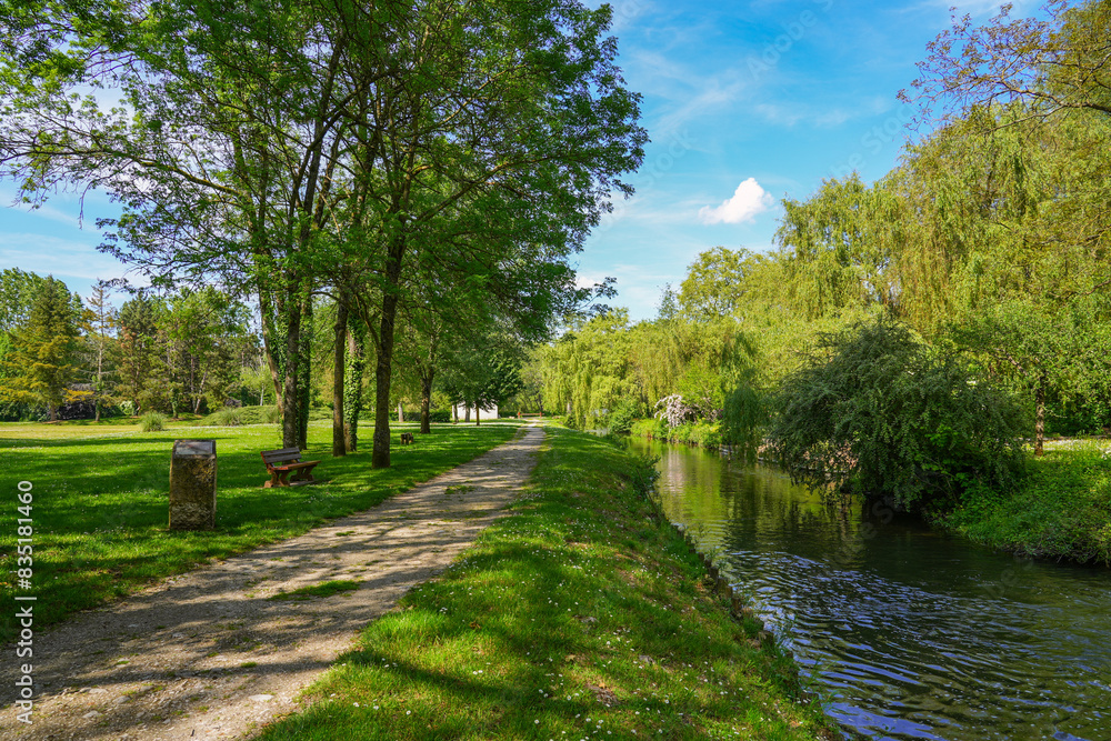 Footpath along the Fusain river in the Parc de la Tabarderie in Château-Landon, a rural village of the Gâtinais in the French department of Seine-et-Marne, Paris Region, France Footpath along the Fusain river in the Parc de la Tabarderie in Château-Landon, a rural village of the Gâtinais in the French department of Seine-et-Marne, Paris Region, France