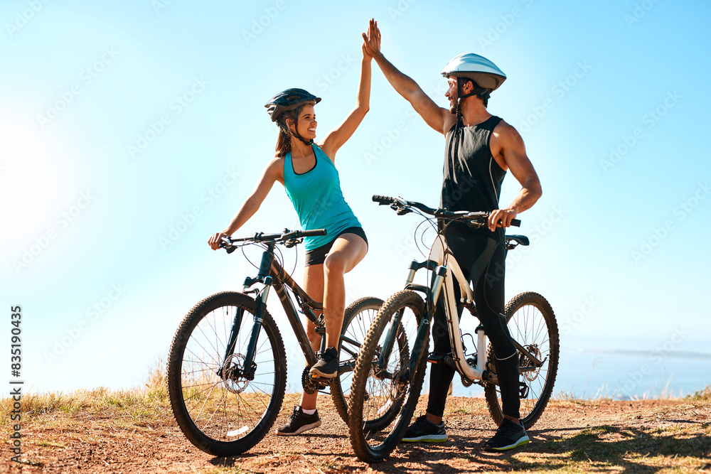 Outdoor, couple and high five in mountain bike by nature for celebration, achievement and training goal. Happy people, man and woman with bicycle for fitness, workout and sports success in Germany Outdoor, couple and high five in mountain bike by nature for celebration, achievement and training goal. Happy people, man and woman with bicycle for fitness, workout and sports success in Germany