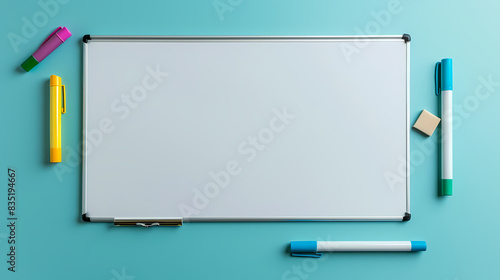 A white board with a few pens and markers on it