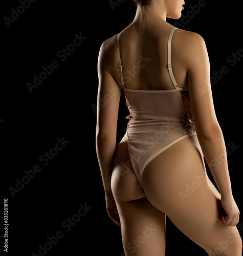 Torso Of Sexy Young Woman In Lingerie Lace Transparent  One-piece Babydoll Bodysuit On Black Background. Back,Rear View