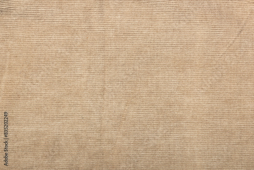 beige corduroy fabric background. slightly worn