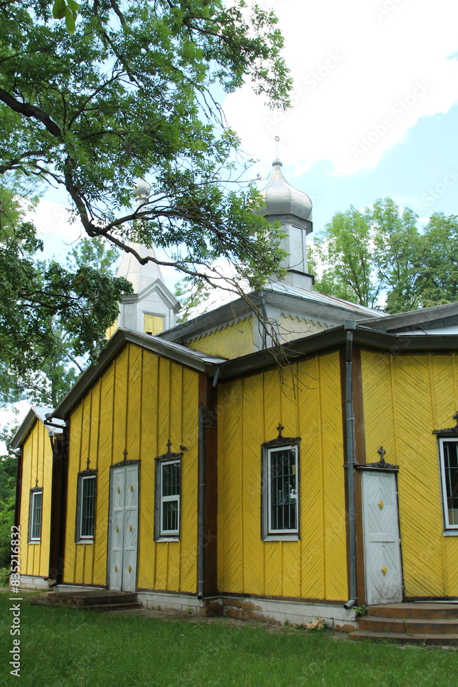 A yellow building with a bell tower with Gordon House in the background A yellow building with a bell tower with Gordon House in the background