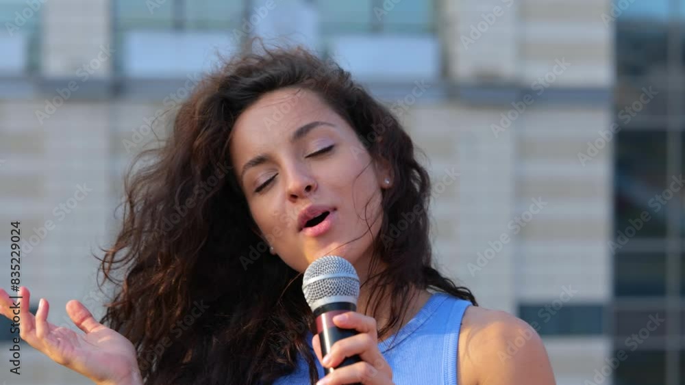 Young happy people having fun dancing outdoor with drinks at a roof party. Man and woman musicians playing small guitar ukulele and singing. Summertime leisure. Slow motion Young happy people having fun dancing outdoor with drinks at a roof party. Man and woman musicians playing small guitar ukulele and singing. Summertime leisure. Slow motion