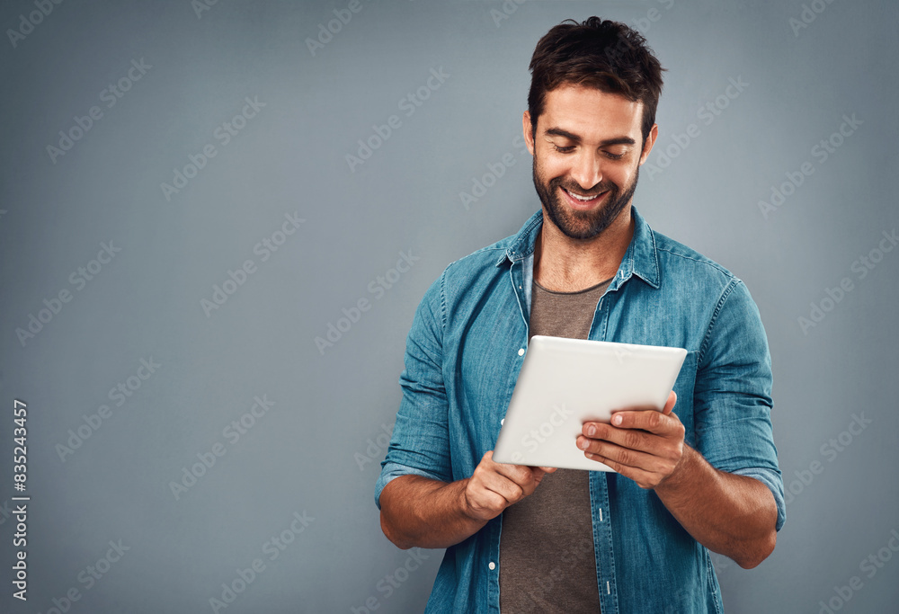 Man, tablet and scroll by white background with smile for social media, internet or website search. Fashion designer, happy and technology for b2b ecommerce, startup and online or digital catalog Man, tablet and scroll by white background with smile for social media, internet or website search. Fashion designer, happy and technology for b2b ecommerce, startup and online or digital catalog