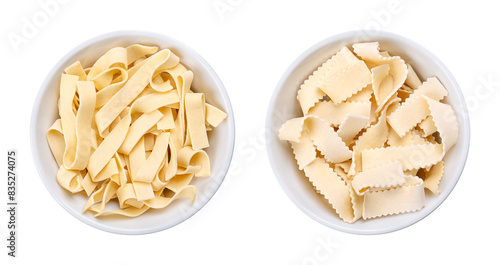 Bild auf Leinwand Two types of short thick ribbon pasta, uncooked durum wheat semolina noodles with egg, Italian laminated pasta in white bowls