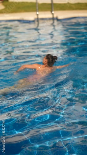 Wallpaper Mural Person swimming in outdoor pool, having a refreshing and relaxing time under the sun Torontodigital.ca