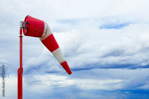 Konstfotografi Red and white weather vane and dramatic cloudy sky.