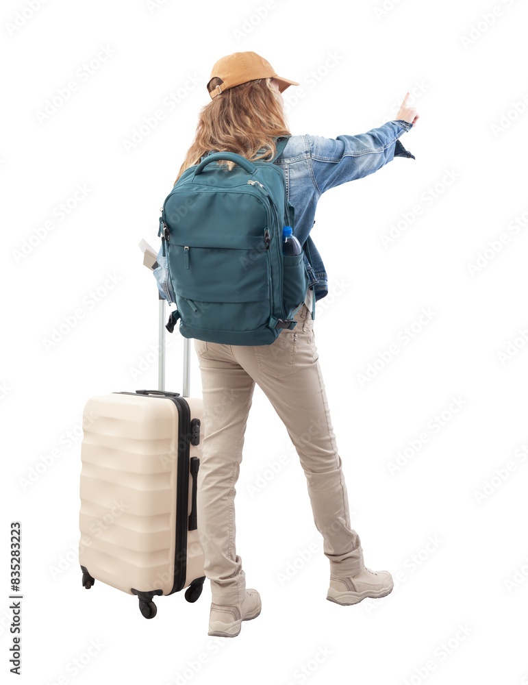 © amedeoemaja - Rear view of a young woman tourist traveling with a backpack and a trolley suitcase, pointing finger forward. Isolated on a white background. Concept of vacation, choice, or online booking