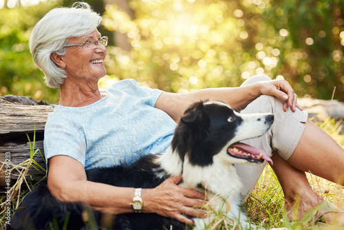 Photography Senior woman, dog and hug in forest to relax for smile, memory or adventure on ground in sunshine