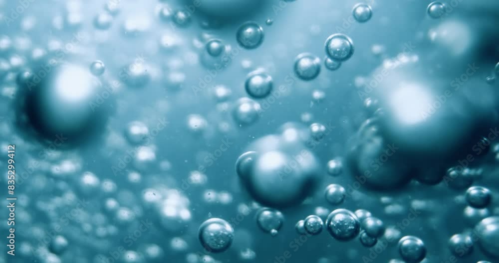Many water bubbles in blue water close up, abstract water wave with bubbles in slow motion. Many water bubbles in blue water close up, abstract water wave with bubbles in slow motion.