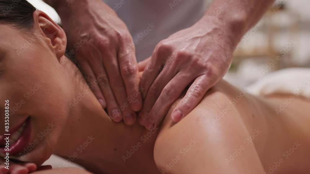 Beautiful Caucasian woman getting relaxing massage for her back. Massagist kneading muscle. Pretty woman with joy visiting spa salon. Improving to appearance and health of skin. Leisure day. Beautiful Caucasian woman getting relaxing massage for her back. Massagist kneading muscle. Pretty woman with joy visiting spa salon. Improving to appearance and health of skin. Leisure day.