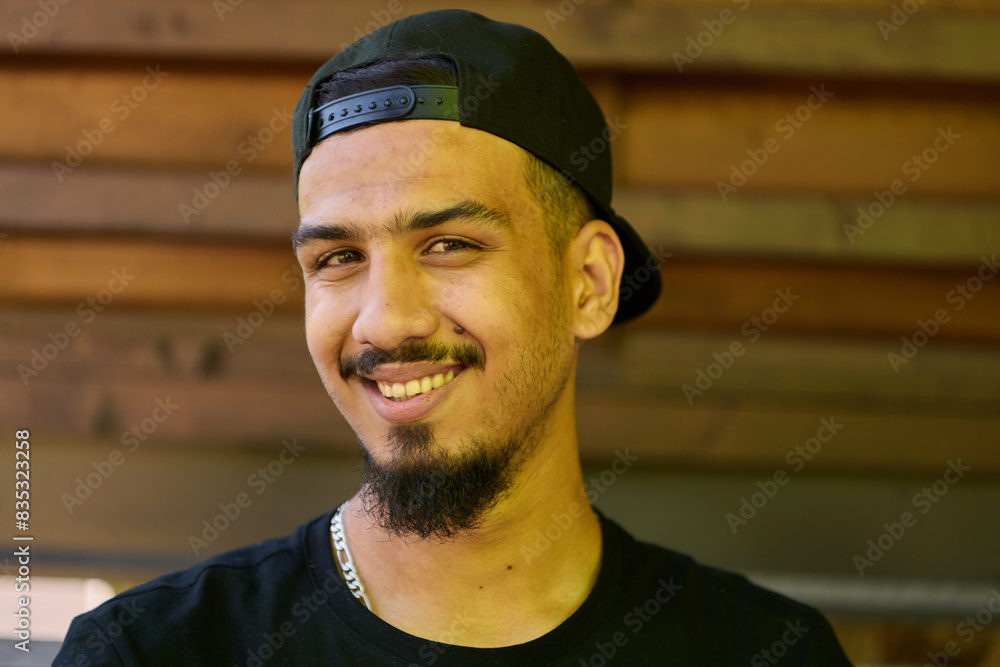 Φωτογραφία Close Up Portrait of Smiling Sudanese Teenager with Broad Smile, Chin, and Cap