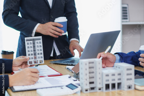 group of businessmen and investors discuss investing in real estate and jointly plan investments in construction projects of condominiums and apartments for sale and rent. investment advisory concept