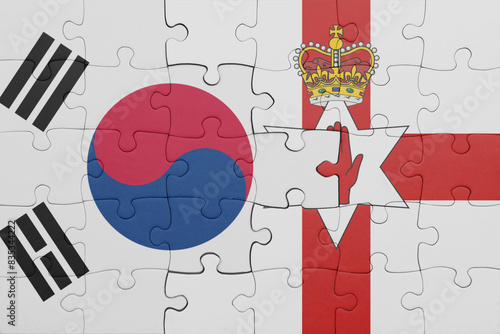 puzzle with the colourful national flag of northern ireland and flag of south korea.