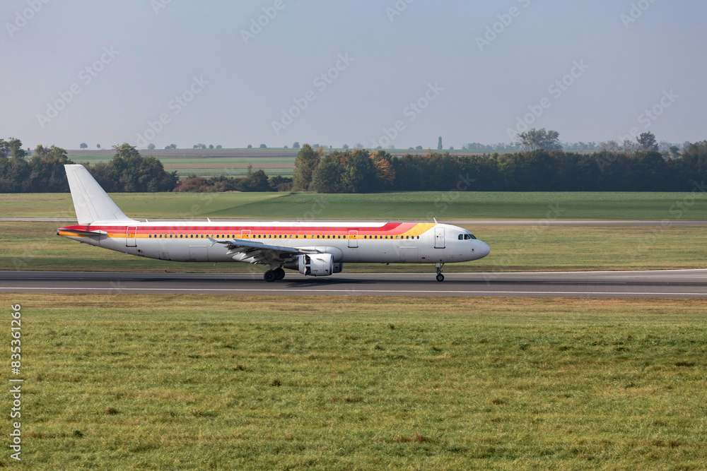 airplane at the airport on the runway using its thrust reversers after touchdown airplane at the airport on the runway using its thrust reversers after touchdown