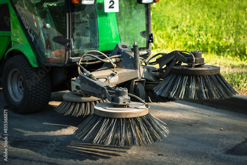 Street Sweeper With Rotating Brushes Cleaning Asphalt Pavement.