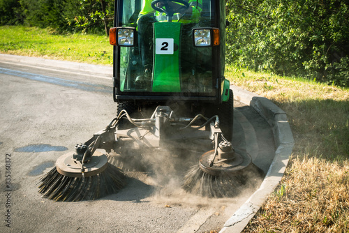 Street Sweeper With Rotating Brushes Cleaning Asphalt Pavement